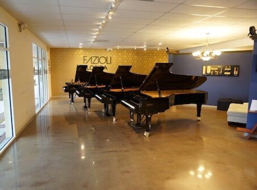 A room with several grand pianos in it.