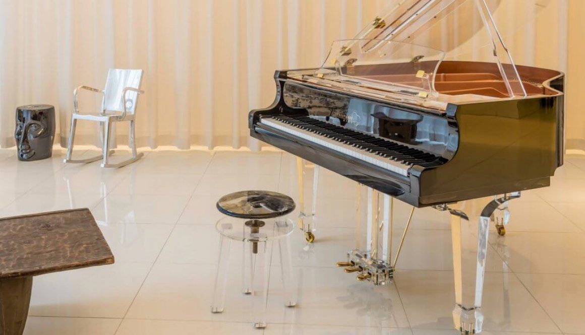 A piano sitting in the middle of a room.