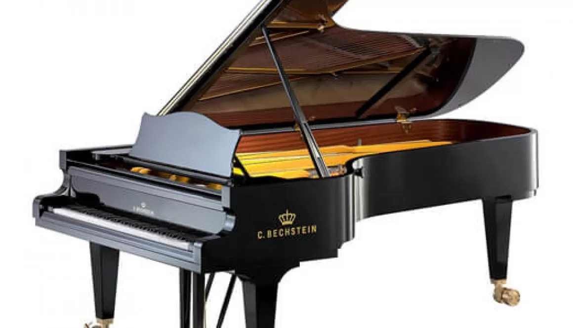 A black piano with yellow interior and wheels.