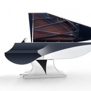A black and white piano is sitting on top of a table.