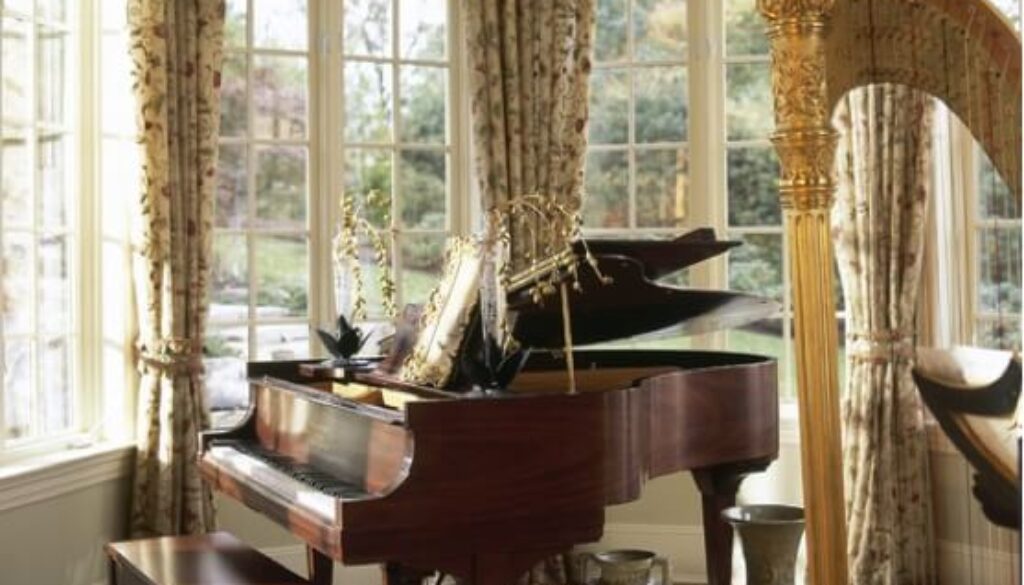 A piano in the corner of a room with curtains.