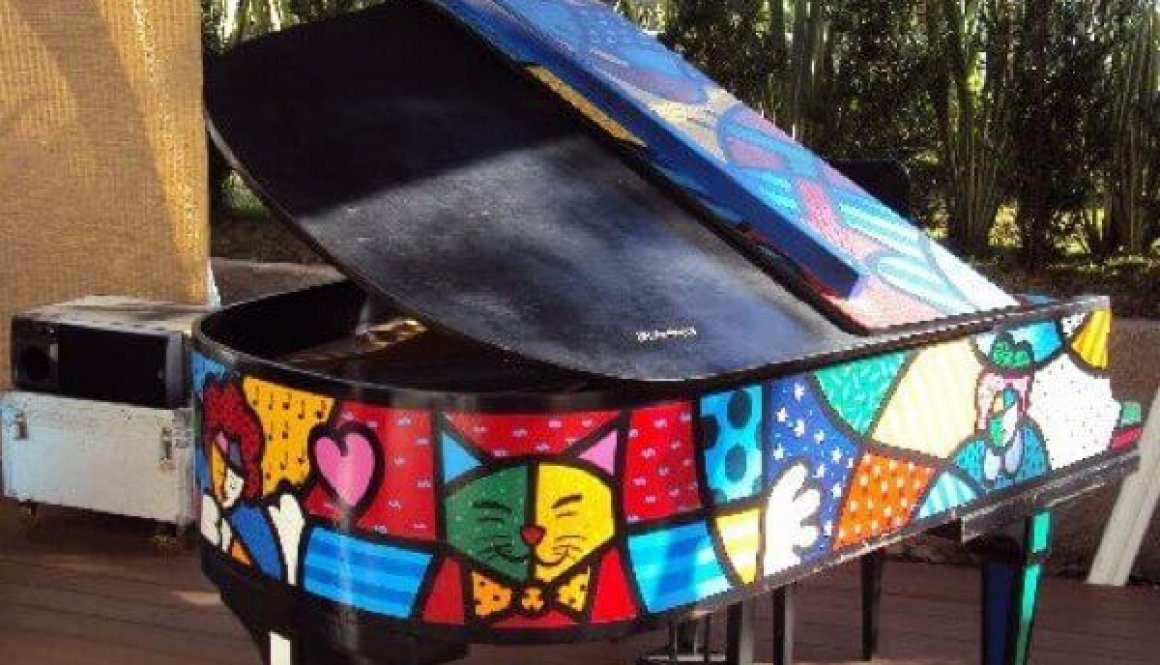 A colorful piano sitting on top of a wooden floor.