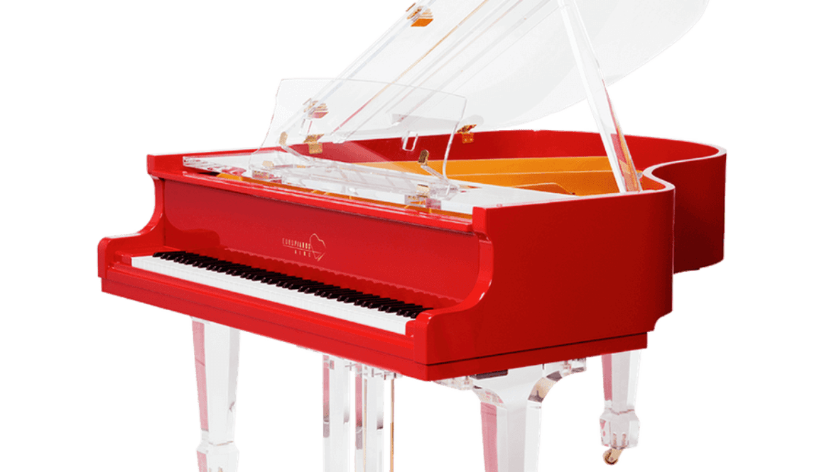 A red piano with white legs and top.