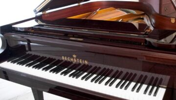 A piano sitting in front of a wall.