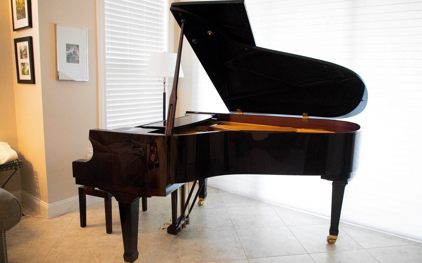 A piano sitting in front of a window.