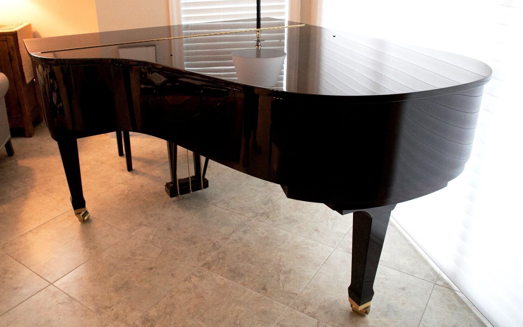 A black piano sitting on top of the floor.